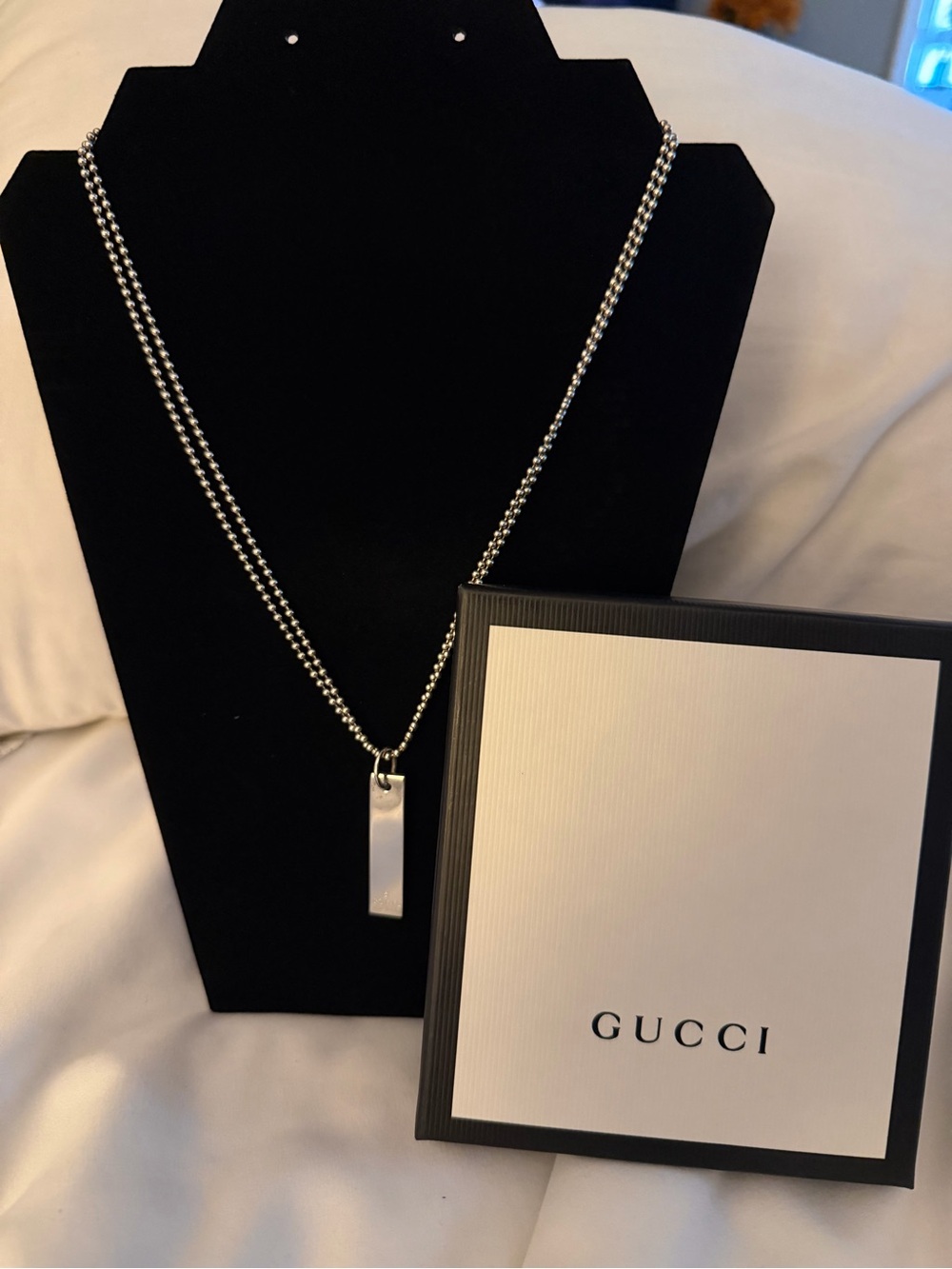 This Gucci sterling silver necklace w/ a rectangle pendant & double ball chain.